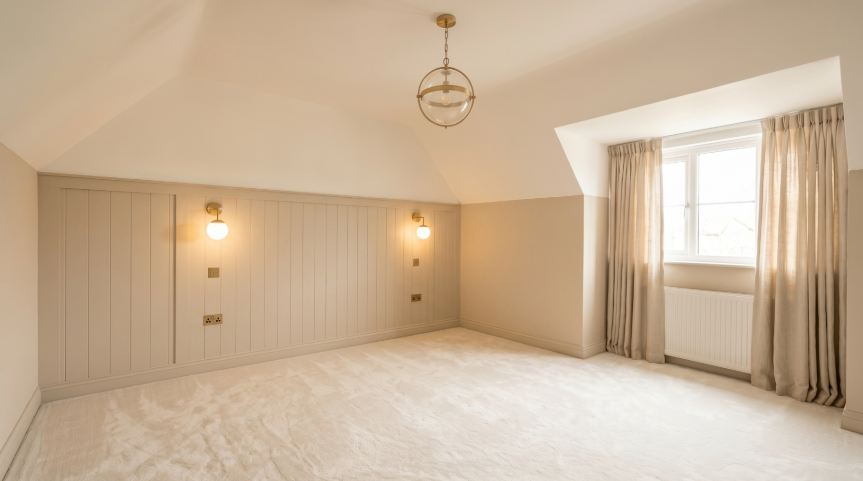 Bedroom with vaulted ceiling, wall panelling and soft carpet