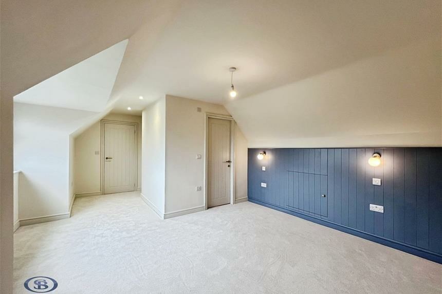 Dormer bedroom with navy panelling