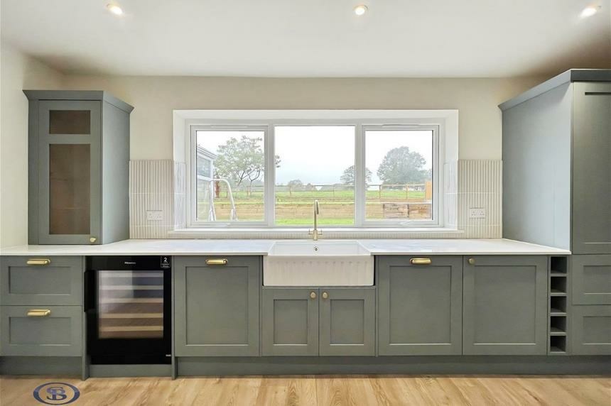 Kitchen run with Belfast sink and countryside view